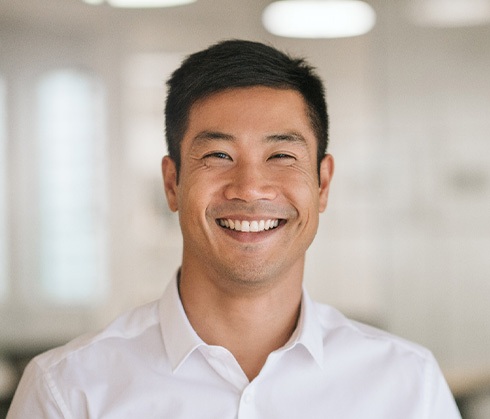 Young man smiling with a damage-free smile