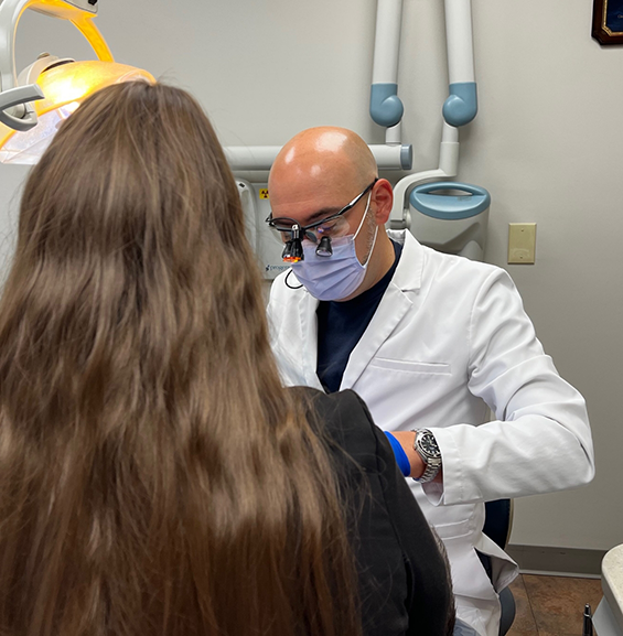 Doctor Bradford Young examining a patient's mouth