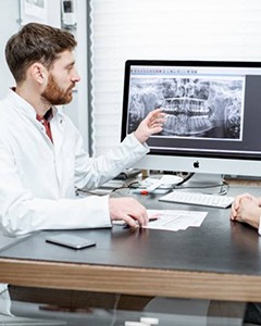 dentist showing a patient their dental X-rays