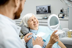 Smiling older woman in dentist’s chair