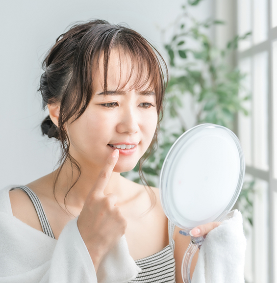 Woman looking at her gums in a mirror
