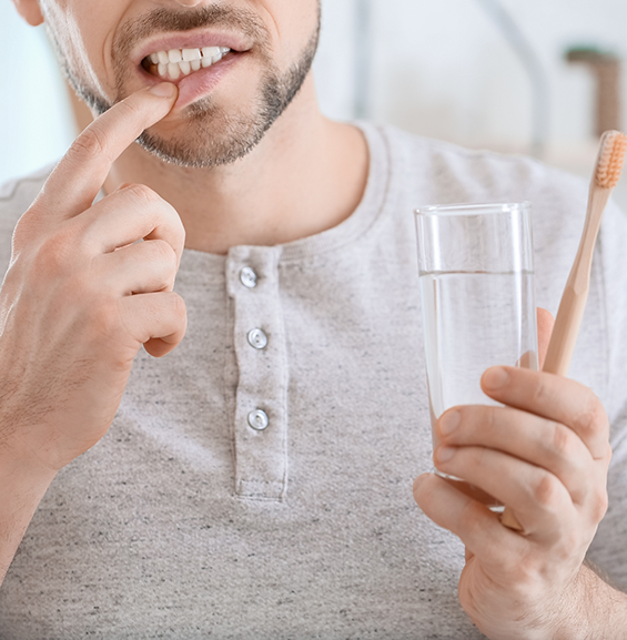 Man pointing to his gums before gum disease treatment in Allentown