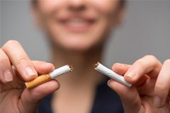 closeup of a person breaking a cigarette