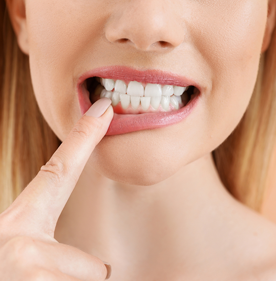 Woman pointing to a red spot in her gums
