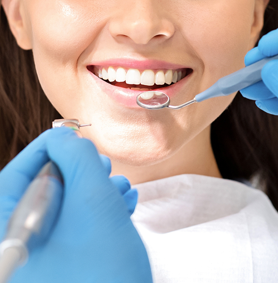 Woman having her mouth examined by her dentist