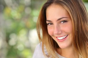 A smiling woman. Your Dentist in 