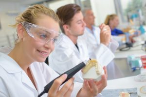 lab worker constructing prosthetic teeth