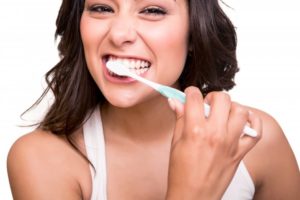 a woman brushing her teeth