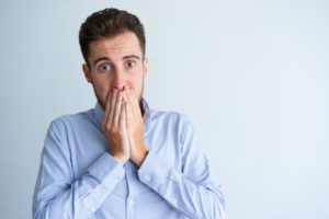 Concerned man with bad breath needs to practice more flossing