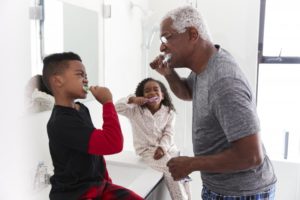 family brushing their teeth in the bathroom 