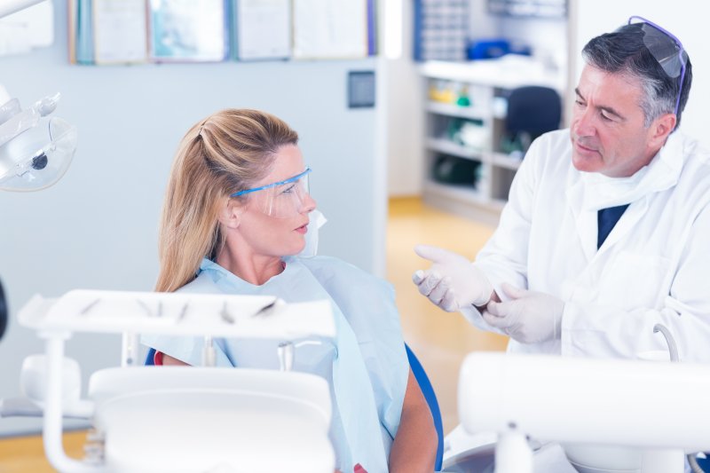 Dentist explaining connection between popcorn and oral health to patient