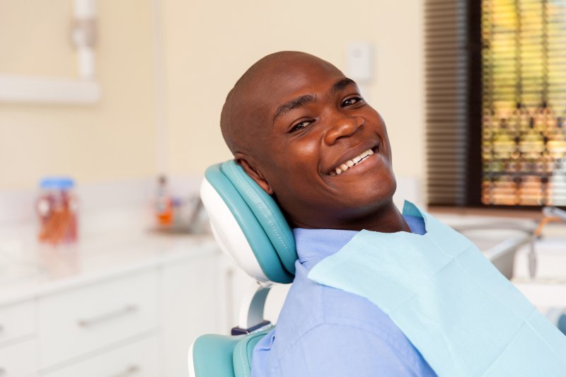 smiling male patient at the dentist after root canal