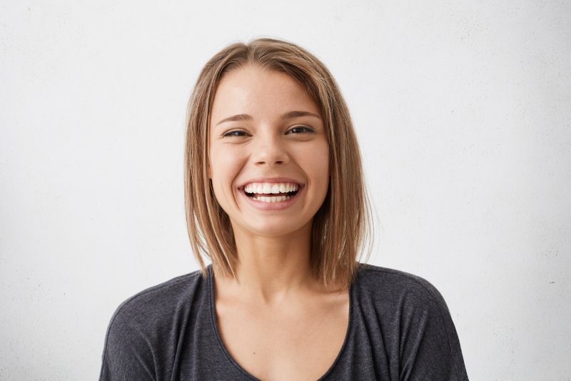 person with porcelain veneers smiling 