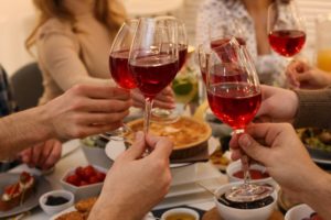 people drinking red wine during holidays