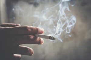 Person smoking cigarette.